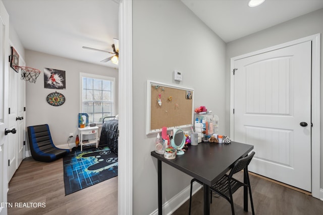 home office featuring wood finished floors, a ceiling fan, and baseboards