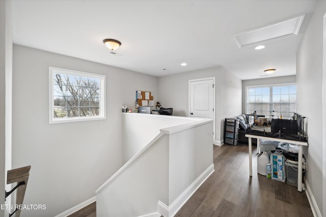 hall featuring dark wood finished floors, recessed lighting, attic access, an upstairs landing, and baseboards