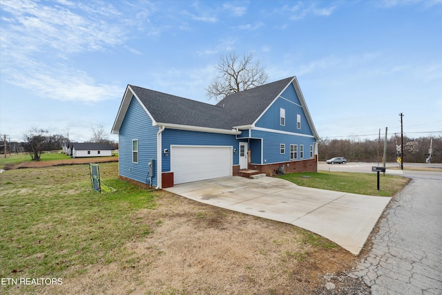 view of front of home with concrete driveway, a front lawn, roof with shingles, and an attached garage