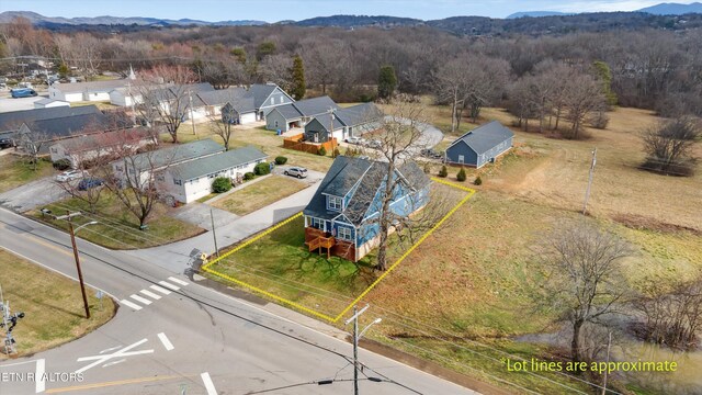 drone / aerial view featuring a residential view and a mountain view