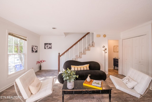 living room with ornamental molding, stairway, visible vents, and baseboards