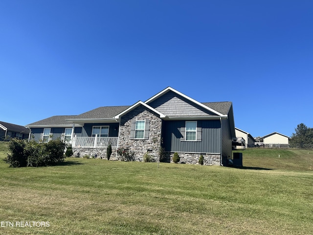 view of front of home featuring a front lawn and covered porch