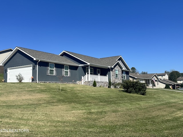 ranch-style home featuring a garage, a front yard, and covered porch