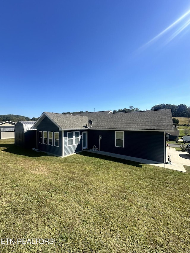 ranch-style home featuring a shed, a patio area, and a front yard