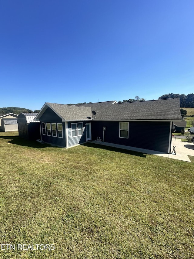 view of front of property featuring a front lawn and a patio area