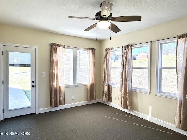 interior space featuring ceiling fan and a textured ceiling