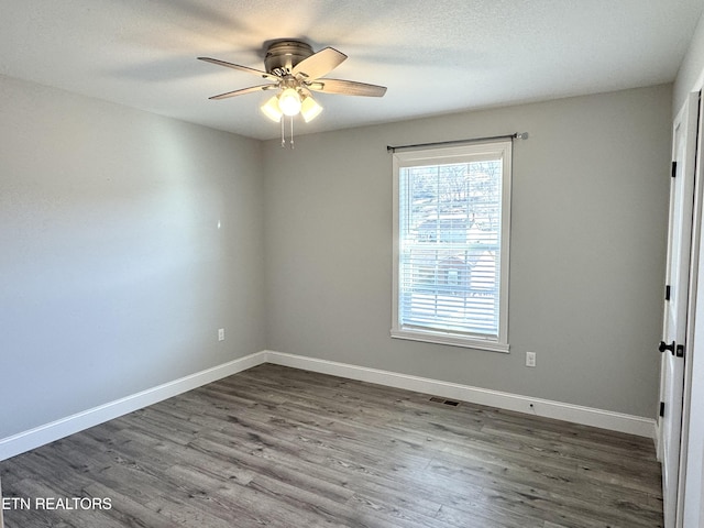 spare room featuring hardwood / wood-style flooring, a textured ceiling, and ceiling fan