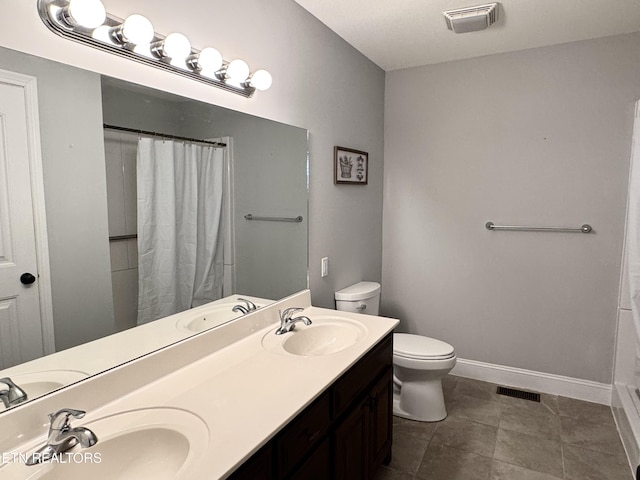 bathroom with a shower with curtain, vanity, toilet, and tile patterned flooring