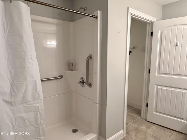 bathroom featuring curtained shower and tile patterned flooring