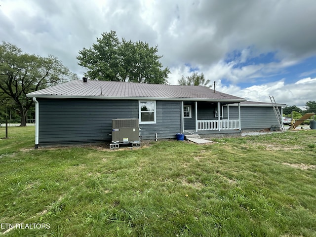 back of property with a porch, central AC unit, and a lawn