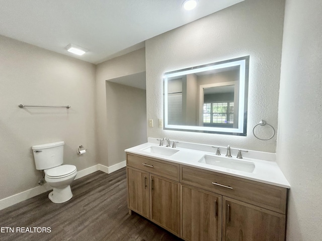 bathroom featuring vanity, hardwood / wood-style floors, and toilet