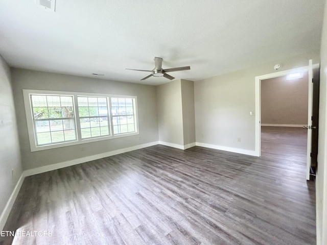 unfurnished room featuring ceiling fan, dark hardwood / wood-style floors, and a textured ceiling