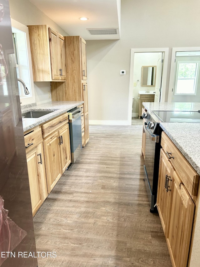 kitchen featuring sink, light hardwood / wood-style flooring, electric range, light brown cabinetry, and stainless steel dishwasher