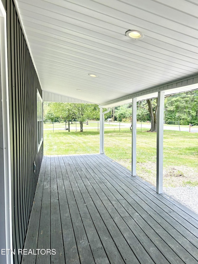 wooden deck with a lawn