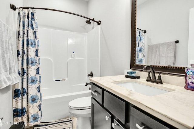 full bathroom featuring vanity, shower / bath combination with curtain, and toilet