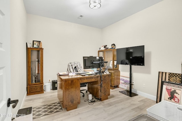 office with light wood-type flooring