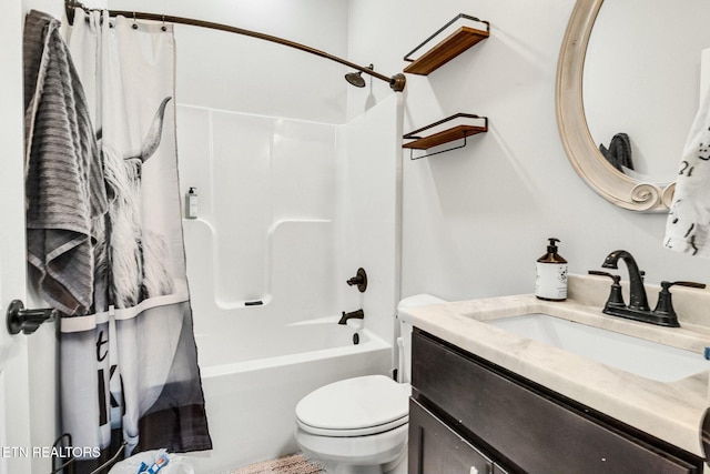 full bathroom featuring vanity, shower / bath combo with shower curtain, and toilet