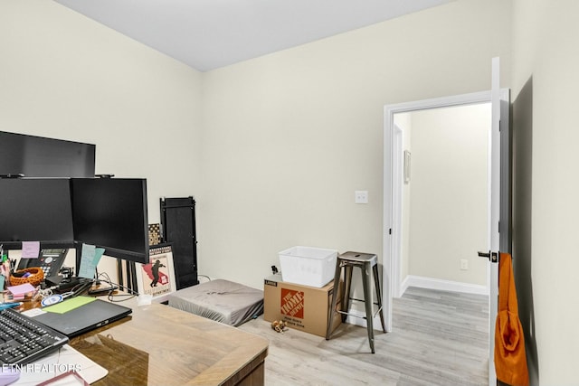 home office with light hardwood / wood-style floors