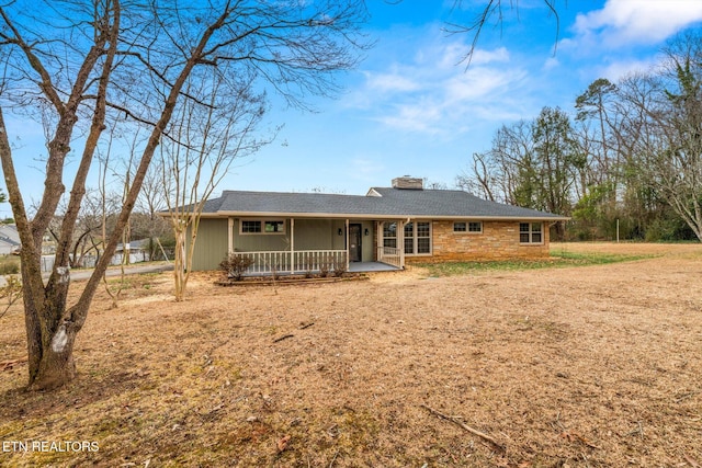 single story home with a front lawn and a porch