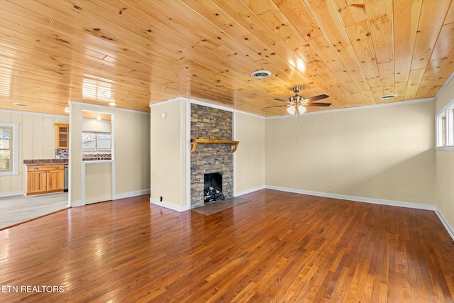 unfurnished living room with hardwood / wood-style flooring, crown molding, and a fireplace