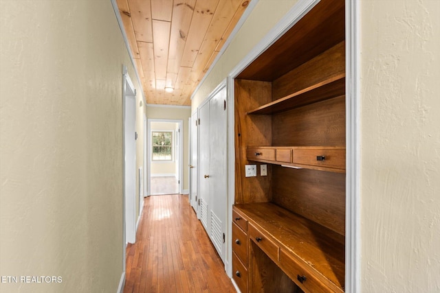 corridor with hardwood / wood-style floors and wood ceiling