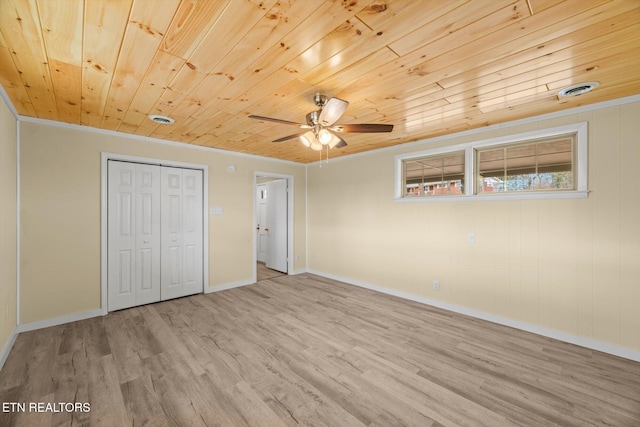 unfurnished bedroom with light hardwood / wood-style flooring, ceiling fan, crown molding, wooden ceiling, and a closet