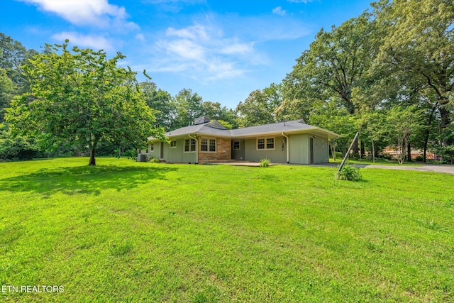 19 Shawnee Trl, Athens, TN 37303 - back of house with asphalt driveway, a lawn, and a chimney