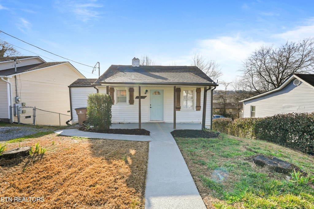 bungalow with a porch and a front yard