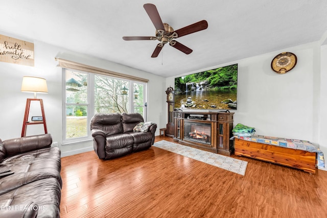 living room with ceiling fan and wood-type flooring