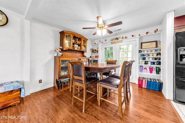 dining area featuring hardwood / wood-style flooring and ceiling fan