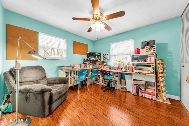 home office with hardwood / wood-style floors and ceiling fan