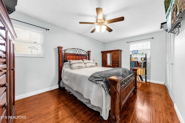 bedroom with dark hardwood / wood-style floors and ceiling fan