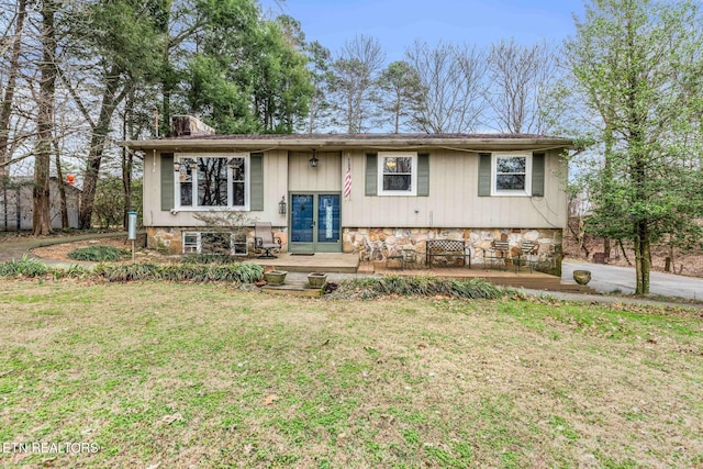 split foyer home with a front yard and french doors