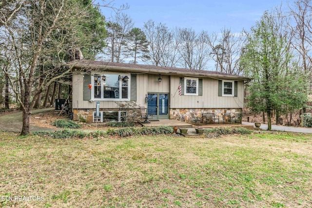 split foyer home featuring french doors, a patio area, and a front yard