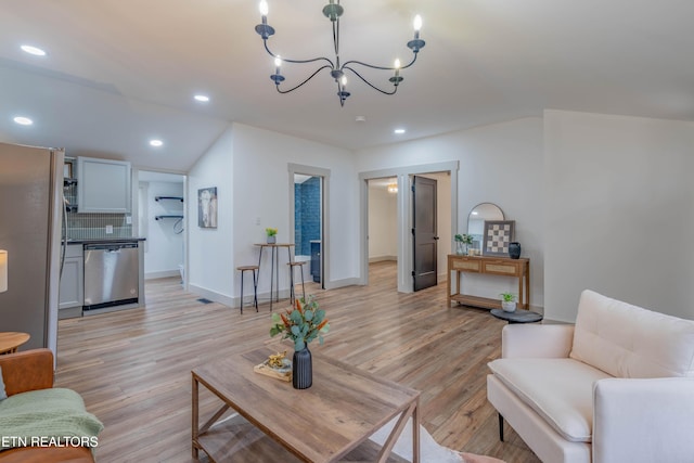 living room featuring a chandelier and light hardwood / wood-style flooring