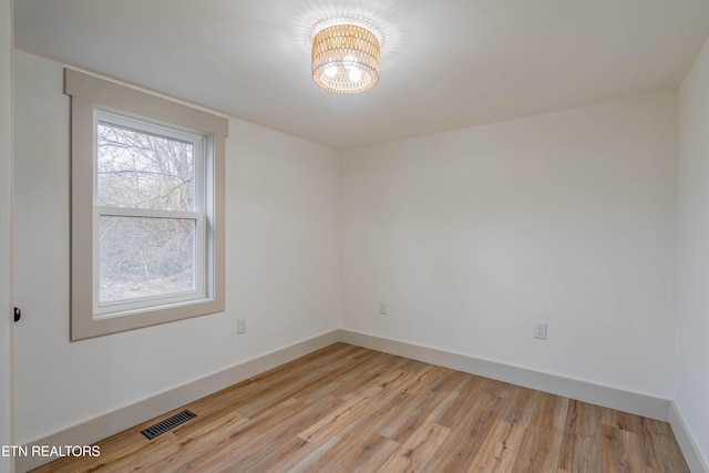 empty room with light hardwood / wood-style floors