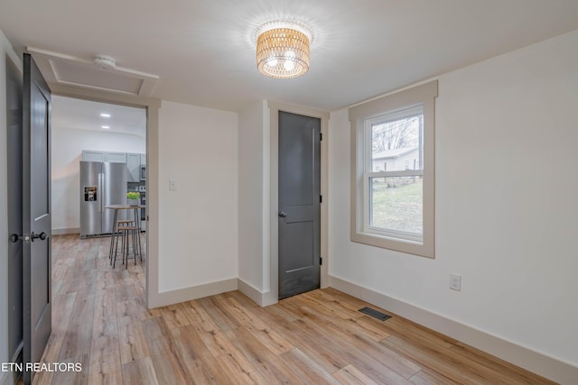 spare room with light hardwood / wood-style flooring