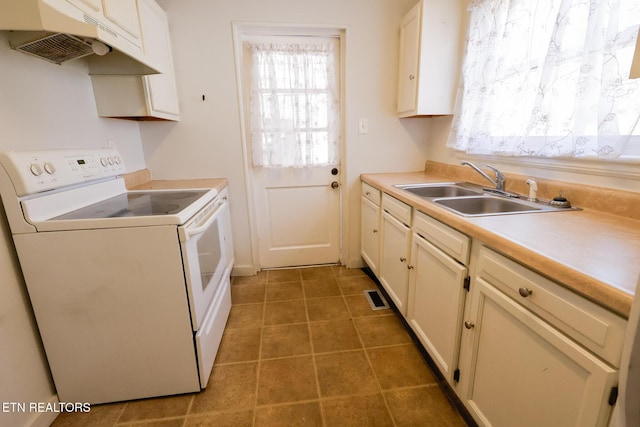 kitchen featuring white electric range oven, visible vents, a sink, under cabinet range hood, and a wealth of natural light