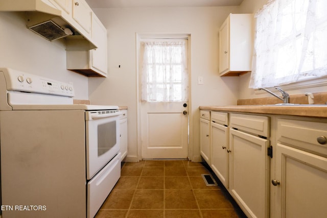 kitchen with tile patterned floors, visible vents, electric stove, a sink, and light countertops