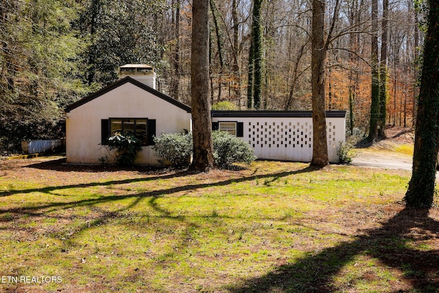 view of yard with a view of trees