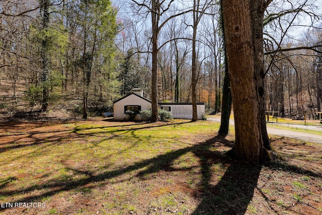 view of yard with a view of trees