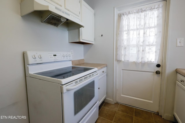 kitchen featuring dark tile patterned flooring, under cabinet range hood, white electric range oven, white cabinets, and light countertops