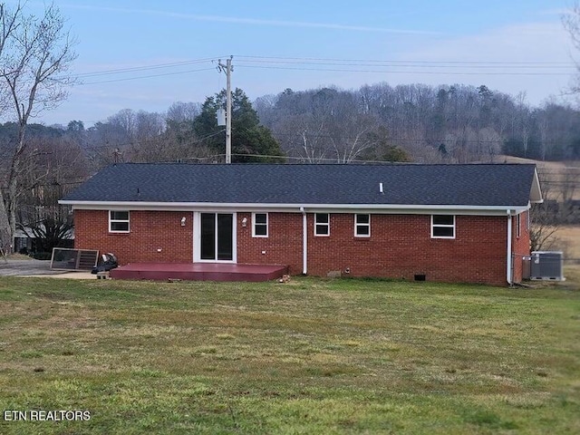 back of house featuring central AC unit, a yard, and a patio area