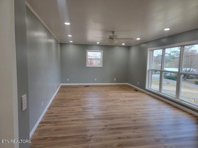 unfurnished room with ceiling fan and wood-type flooring