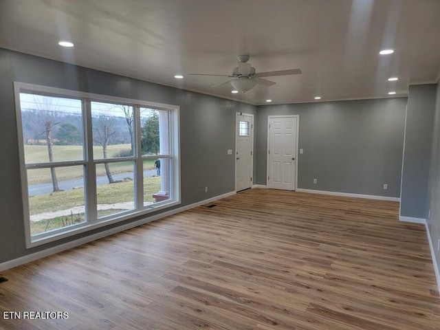 empty room with hardwood / wood-style flooring and ceiling fan