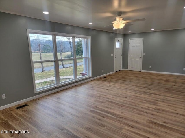 spare room with hardwood / wood-style flooring and ceiling fan