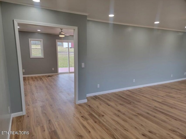 spare room with ornamental molding, ceiling fan, and light hardwood / wood-style floors