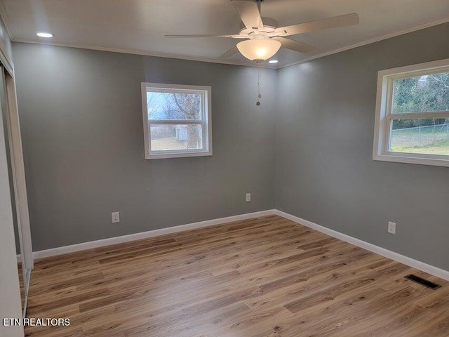 unfurnished room with crown molding, ceiling fan, and light wood-type flooring