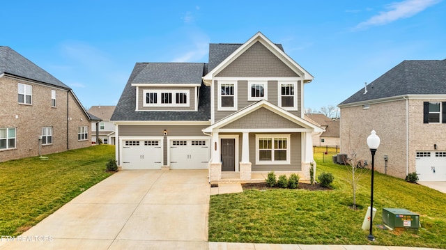 craftsman-style house featuring a garage and a front lawn