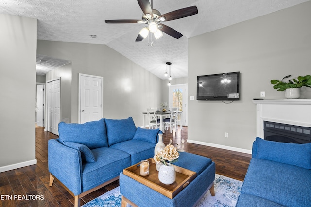 living room featuring ceiling fan, dark hardwood / wood-style floors, a textured ceiling, and lofted ceiling